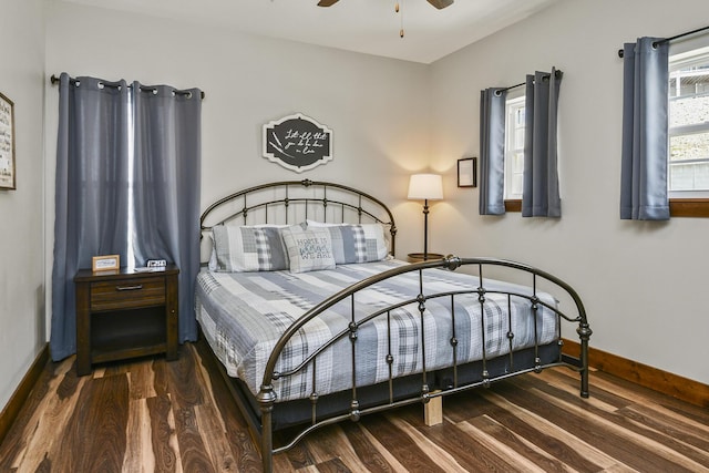bedroom featuring wood finished floors and baseboards