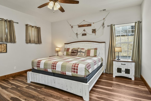 bedroom featuring a ceiling fan, visible vents, wood finished floors, and baseboards