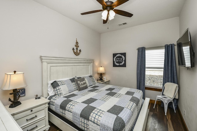bedroom with baseboards, ceiling fan, visible vents, and dark wood-style floors