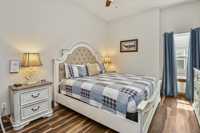 bedroom featuring baseboards, dark wood-style floors, and a ceiling fan