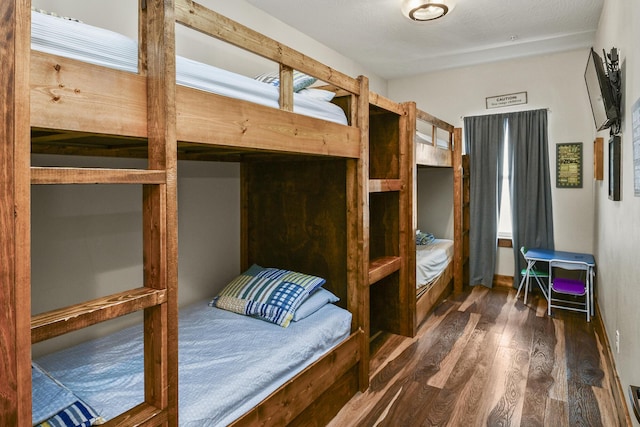 bedroom featuring dark wood-style floors and visible vents