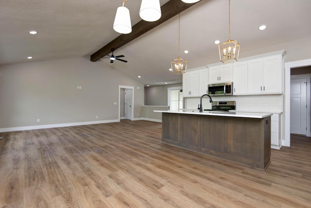 385 Plumtree Dr, Ozark, MO 65721 - kitchen with white cabinetry, stainless steel appliances, light wood-type flooring, and ceiling fan with notable chandelier