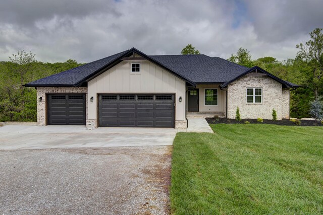 385 Plumtree Dr, Ozark, MO 65721 - view of front of property featuring roof with shingles, a front yard, a garage, and driveway