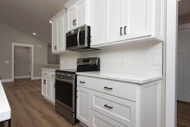 385 Plumtree Dr, Ozark, MO 65721 - kitchen with lofted ceiling, white cabinets, tasteful backsplash, appliances with stainless steel finishes, and dark wood-style floors
