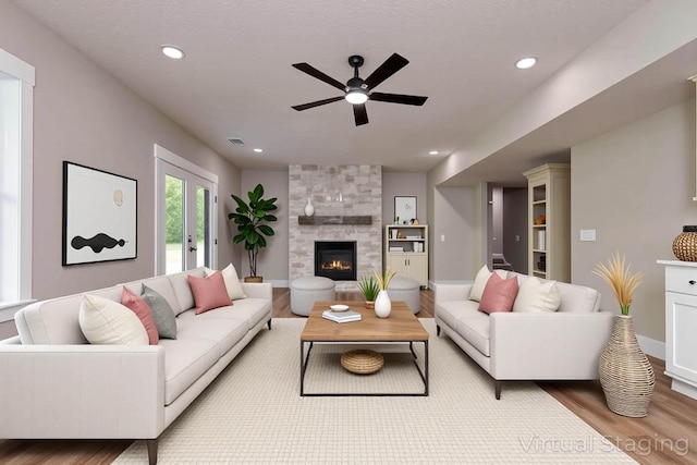 385 Plumtree Dr, Ozark, MO 65721 - living area featuring a fireplace, ceiling fan, baseboards, and wood finished floors