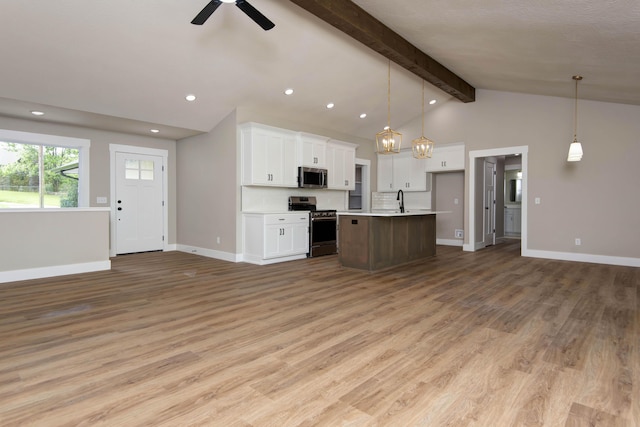 385 Plumtree Dr, Ozark, MO 65721 - kitchen featuring light wood-style flooring, stainless steel appliances, lofted ceiling with beams, open floor plan, and baseboards