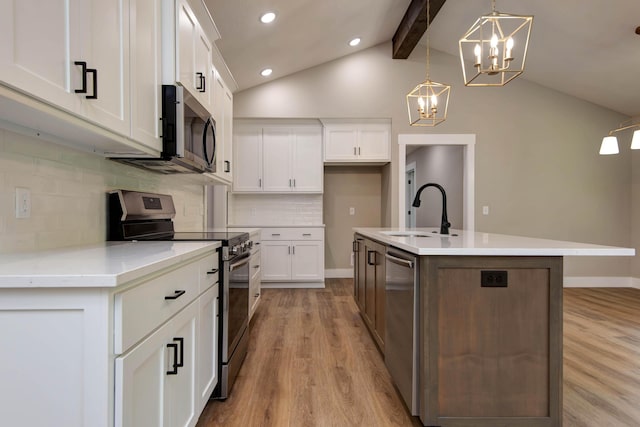 385 Plumtree Dr, Ozark, MO 65721 - kitchen with light wood finished floors, a sink, a chandelier, lofted ceiling with beams, and appliances with stainless steel finishes