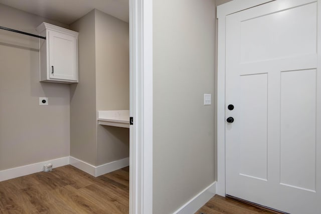 385 Plumtree Dr, Ozark, MO 65721 - clothes washing area with cabinet space, wood finished floors, baseboards, and electric dryer hookup