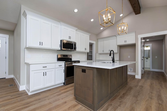 385 Plumtree Dr, Ozark, MO 65721 - kitchen featuring a sink, stainless steel appliances, lofted ceiling with beams, a notable chandelier, and light countertops