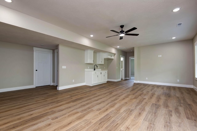385 Plumtree Dr, Ozark, MO 65721 - unfurnished living room with a sink, baseboards, ceiling fan, light wood-style floors, and recessed lighting