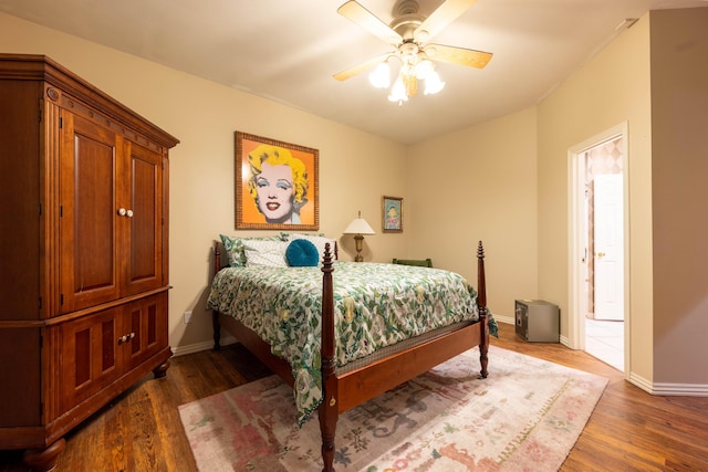 bedroom with baseboards, a ceiling fan, and wood finished floors
