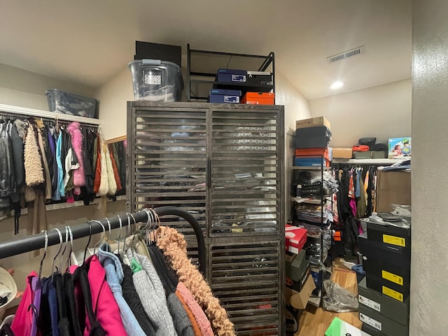 walk in closet featuring visible vents and wood finished floors