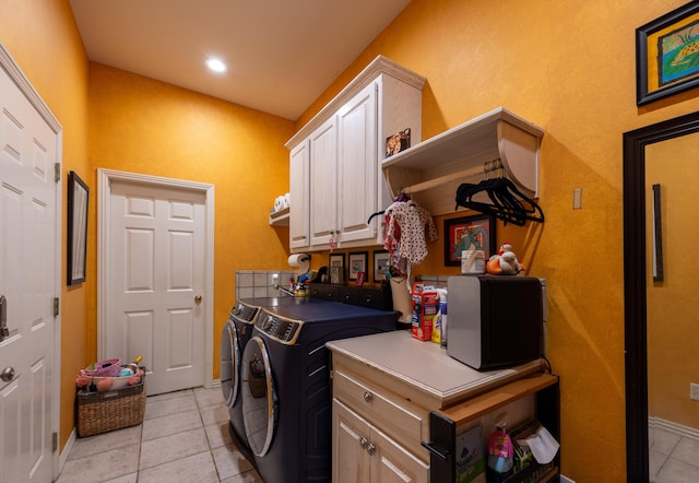 clothes washing area with light tile patterned floors, cabinet space, washer and clothes dryer, baseboards, and recessed lighting