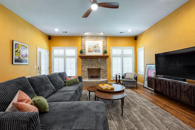 living room featuring a wealth of natural light, visible vents, wood finished floors, and a ceiling fan