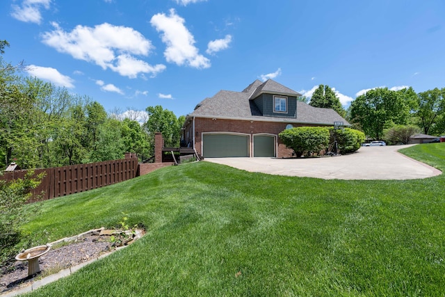 view of property exterior with fence, an attached garage, brick siding, a yard, and concrete driveway