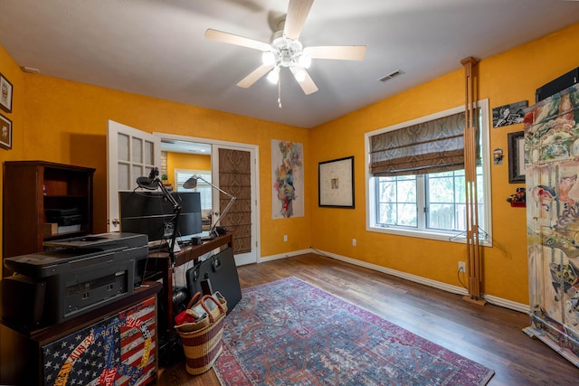 office with baseboards, ceiling fan, visible vents, and wood finished floors