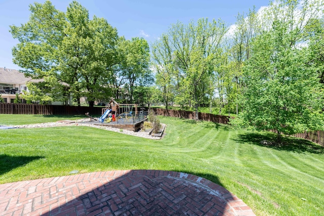 view of yard with a playground and a fenced backyard