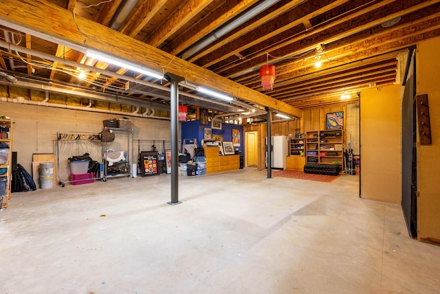 unfinished below grade area with freestanding refrigerator