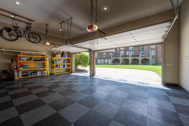 garage with recessed lighting and a garage door opener