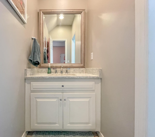 bathroom with vanity and baseboards