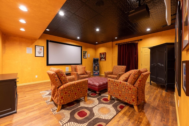 home theater with light wood finished floors, baseboards, and recessed lighting