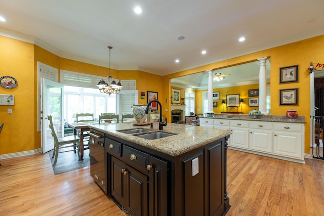 kitchen featuring white cabinetry, ornamental molding, and a sink