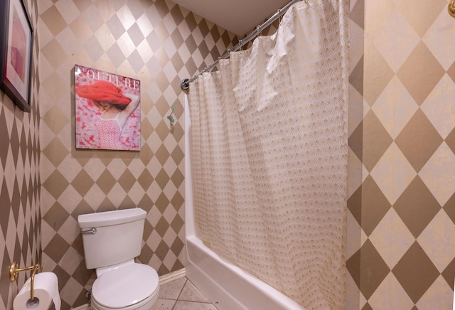 full bath with toilet, tile patterned floors, and shower / bath combo with shower curtain