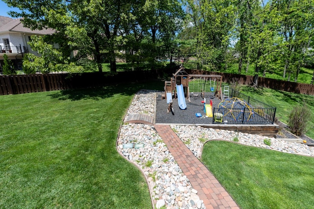 view of yard featuring a playground and a fenced backyard