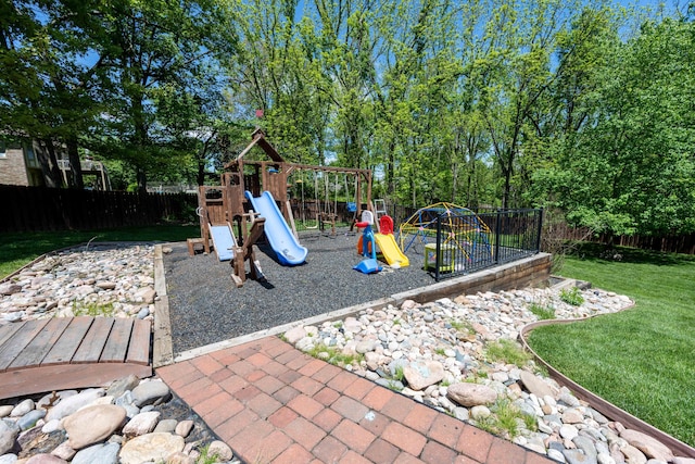 view of jungle gym with a yard and a fenced backyard
