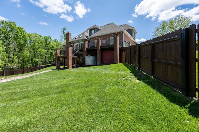 view of yard featuring a fenced backyard, stairs, and a wooden deck