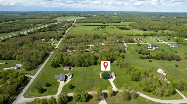 birds eye view of property with a rural view