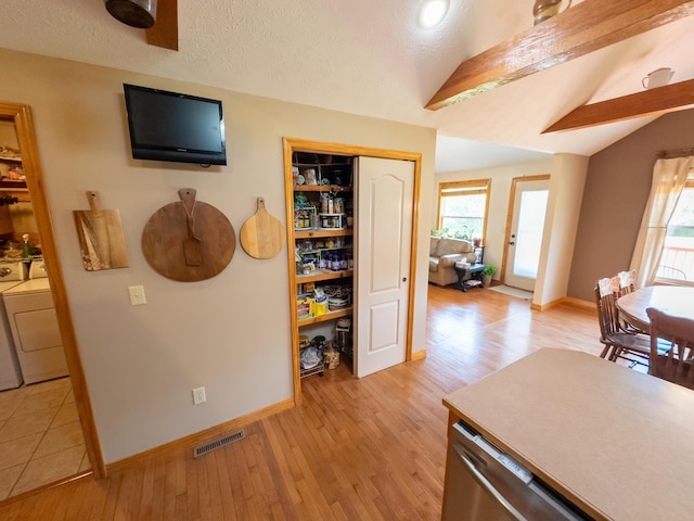 interior space with a wealth of natural light, light wood-style floors, and vaulted ceiling