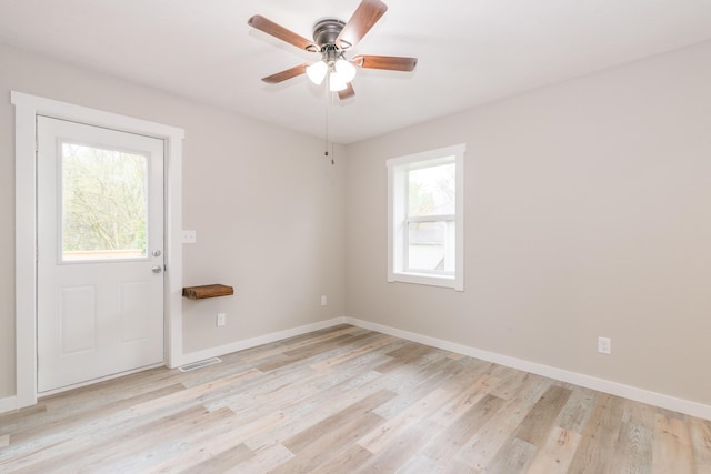 spare room with ceiling fan, light wood-style flooring, baseboards, and visible vents