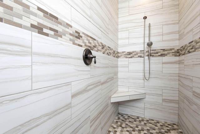 full bath featuring a tile shower