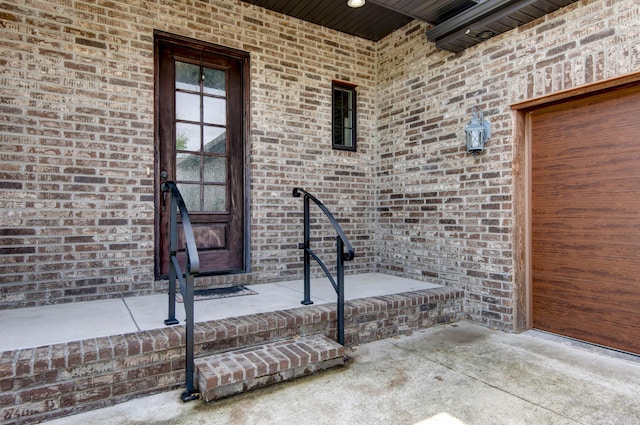 property entrance featuring brick siding