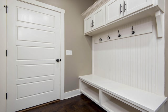 mudroom featuring baseboards and dark wood-style floors