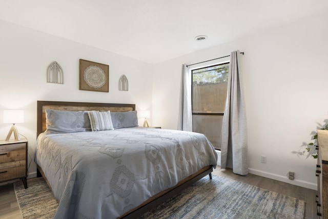 112 Overlook Dr Unit 2, Branson, MO 65616 - bedroom with baseboards, visible vents, and wood finished floors