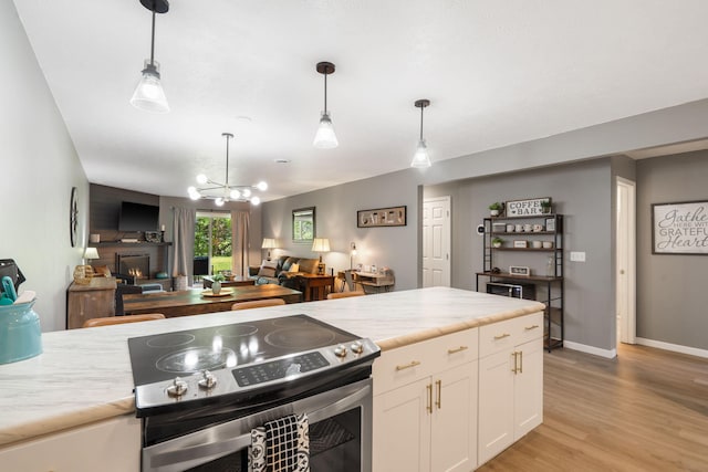 112 Overlook Dr Unit 2, Branson, MO 65616 - kitchen with white cabinetry, light countertops, open floor plan, and stainless steel electric range