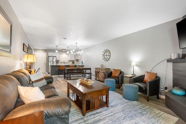 112 Overlook Dr Unit 2, Branson, MO 65616 - living room featuring light wood finished floors, a notable chandelier, and baseboards