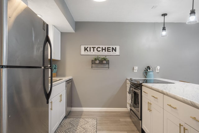 112 Overlook Dr Unit 2, Branson, MO 65616 - kitchen with white cabinetry, light countertops, stainless steel appliances, and light wood-type flooring