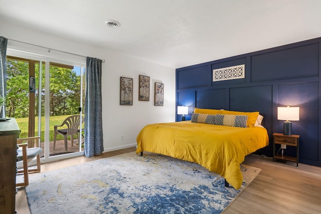 112 Overlook Dr Unit 2, Branson, MO 65616 - bedroom featuring baseboards, wood finished floors, visible vents, and access to exterior