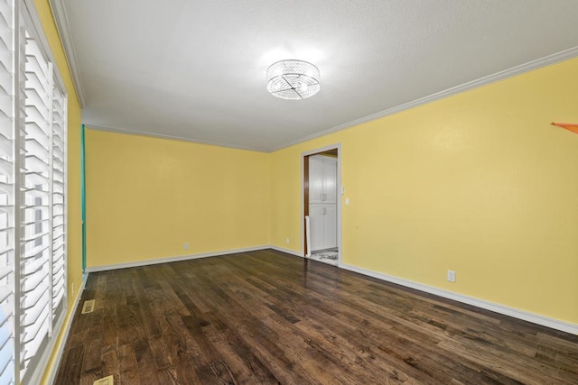 spare room with baseboards, dark wood-style flooring, crown molding, and a wealth of natural light