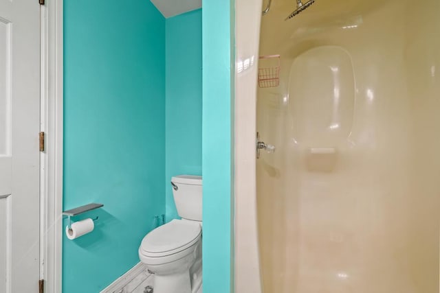 full bathroom with toilet, walk in shower, and baseboards