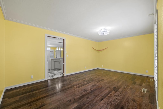 unfurnished room with ornamental molding, visible vents, and wood finished floors
