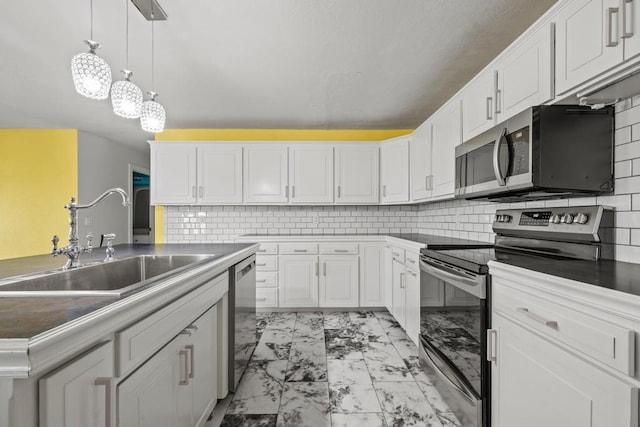 kitchen with a sink, white cabinetry, marble finish floor, and appliances with stainless steel finishes
