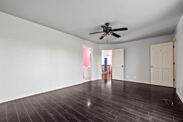 spare room with a ceiling fan, baseboards, and wood finished floors