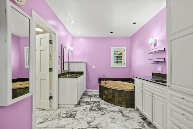 full bathroom featuring a bath, marble finish floor, two vanities, and a sink