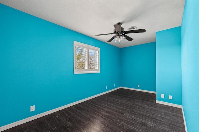 empty room featuring baseboards, a ceiling fan, and wood finished floors