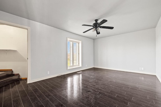 unfurnished living room featuring wood finished floors, baseboards, and ceiling fan