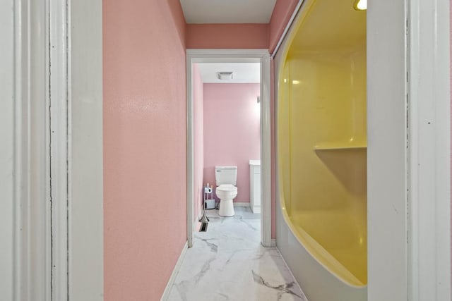 bathroom with a tub, toilet, visible vents, and marble finish floor
